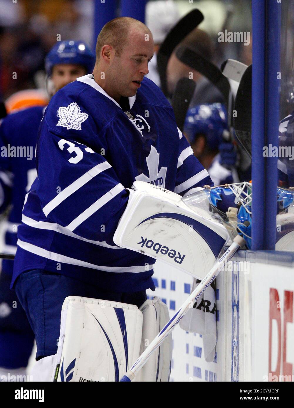 Toronto Maple Leafs goalie J.S. Giguere stands by the bench during a break  in the third period of their NHL pre-season hockey game against the  Philadelphia Flyers in Toronto September 24, 2010.