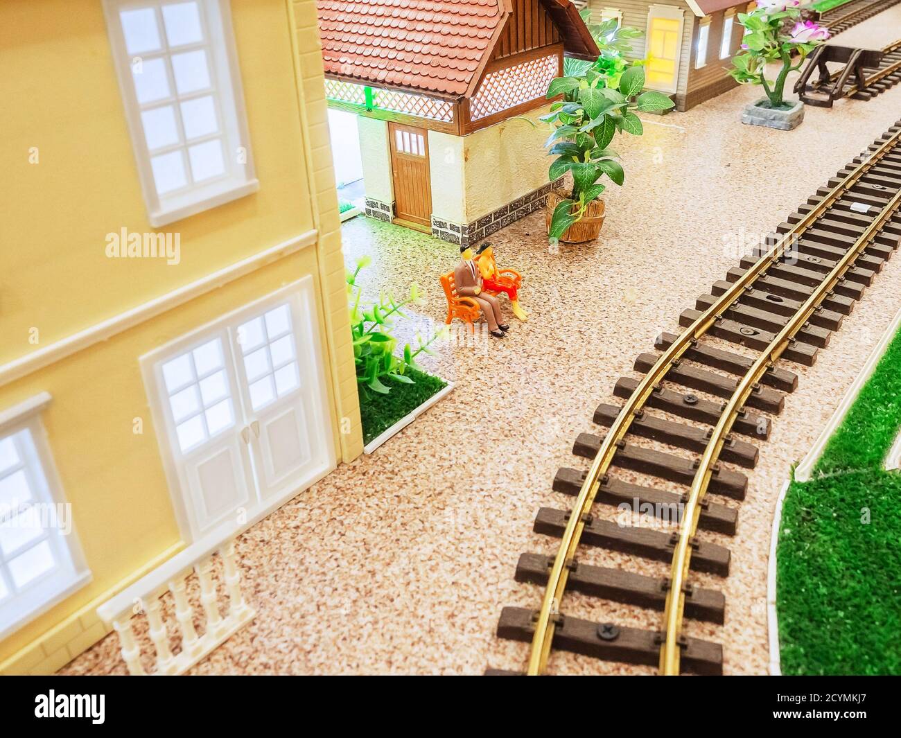 Miniature railway with small houses and little men on a bench Stock ...