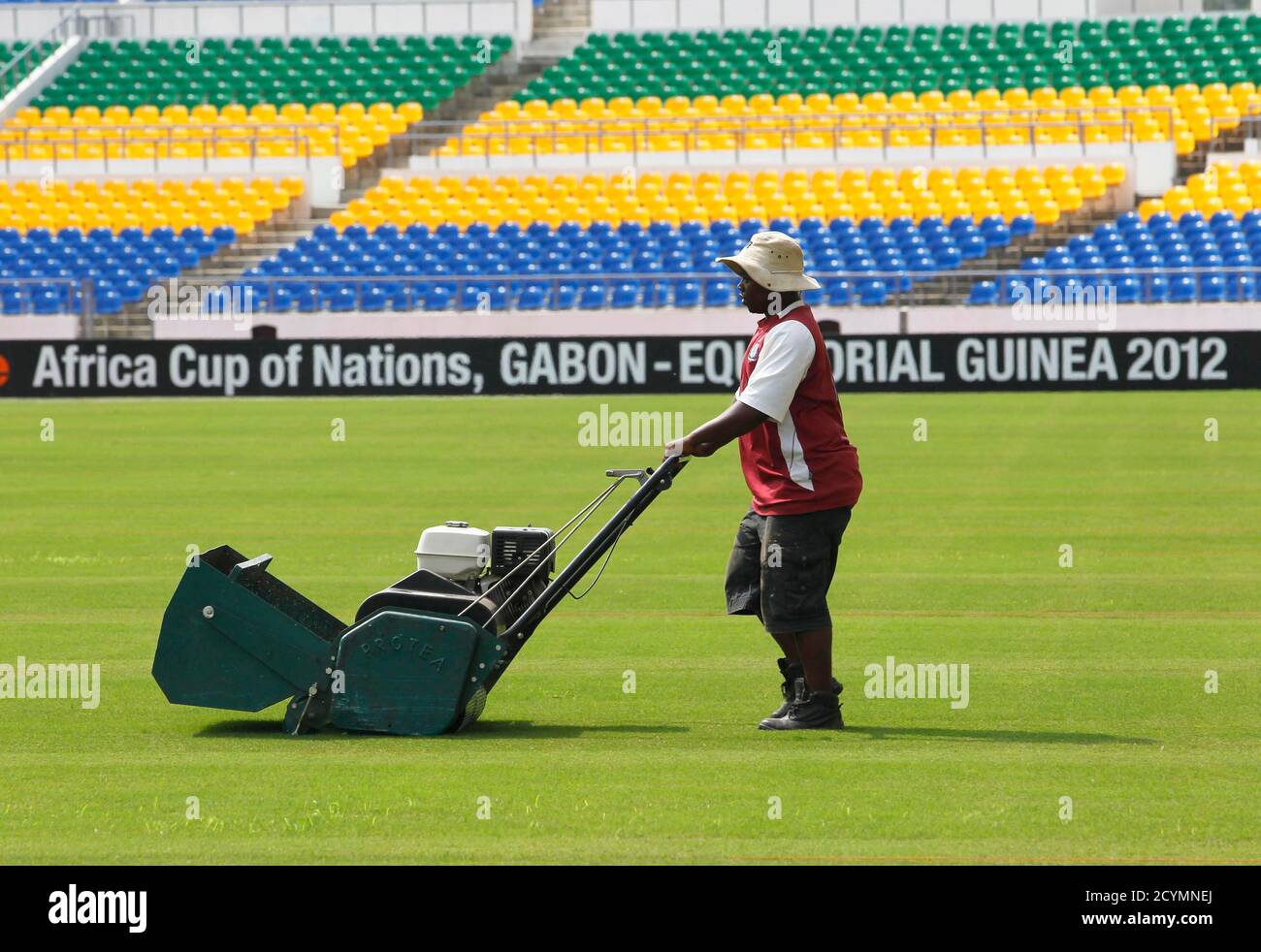 A field crew member prepares the grass at the Sino-Gabonese Friendship Stadium, which will host the final match for the African Nations Cup, in Libreville January 20, 2012. The African Nations Cup is being co-hosted by Equatorial Guinea and Gabon from January 21 to February 12. REUTERS/Louafi Larbi (Gabon - Tags: SPORT SOCCER) Stock Photo