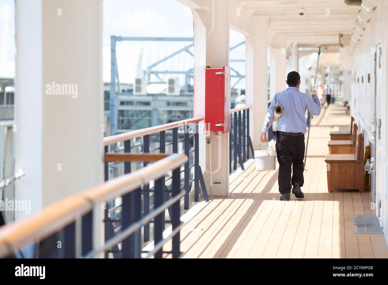 Filipino cruise ship worker painting and performing general maintenance