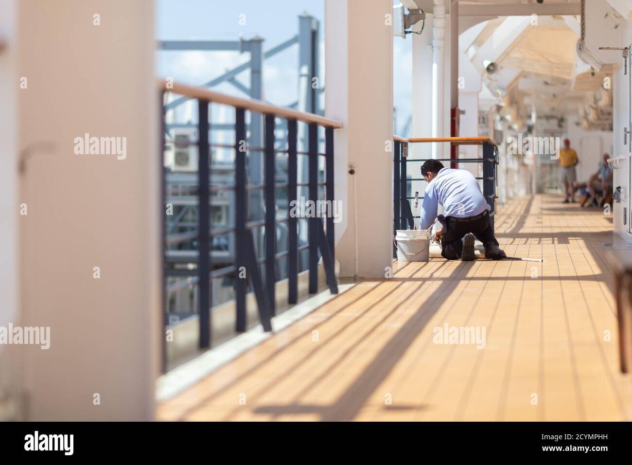 Filipino cruise ship worker painting and performing general maintenance