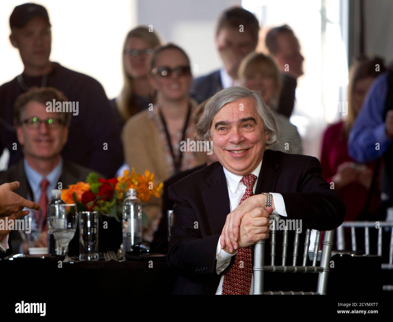 United States Secretary of Energy Ernest Moniz listens to speakers during the grand opening of the Ivanpah Solar Electric Generating System in the Mojave Desert near the California-Nevada border February 13, 2014. The project, a partnership of NRG, BrightSource, Google and Bechtel, is the world's largest solar thermal facility and uses 347,000 sun-facing mirrors to produce 392 Megawatts of electricity, enough energy to power more than 140,000 homes. REUTERS/Steve Marcus (UNITED STATES - Tags: ENERGY SCIENCE TECHNOLOGY BUSINESS) Stock Photo