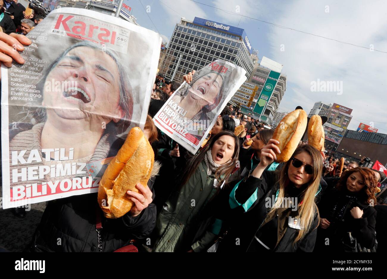 Anti-government protesters carry posters of Berkin Elvan's mother and bread during a demonstration marking the funeral of Elvan in Ankara March 12, 2014. Several thousand mourners gathered in central Istanbul and Ankara on Wednesday for the funeral of Elvan, a 15-year-old boy wounded during anti-government demonstrations last summer whose death on Tuesday triggered protests across Turkey. Elvan, then aged 14, got caught up in street battles in Istanbul between police and protesters on June 16, 2013 while going to buy bread for his family. REUTERS/Umit Bektas (TURKEY  - Tags: POLITICS CIVIL UNR Stock Photo