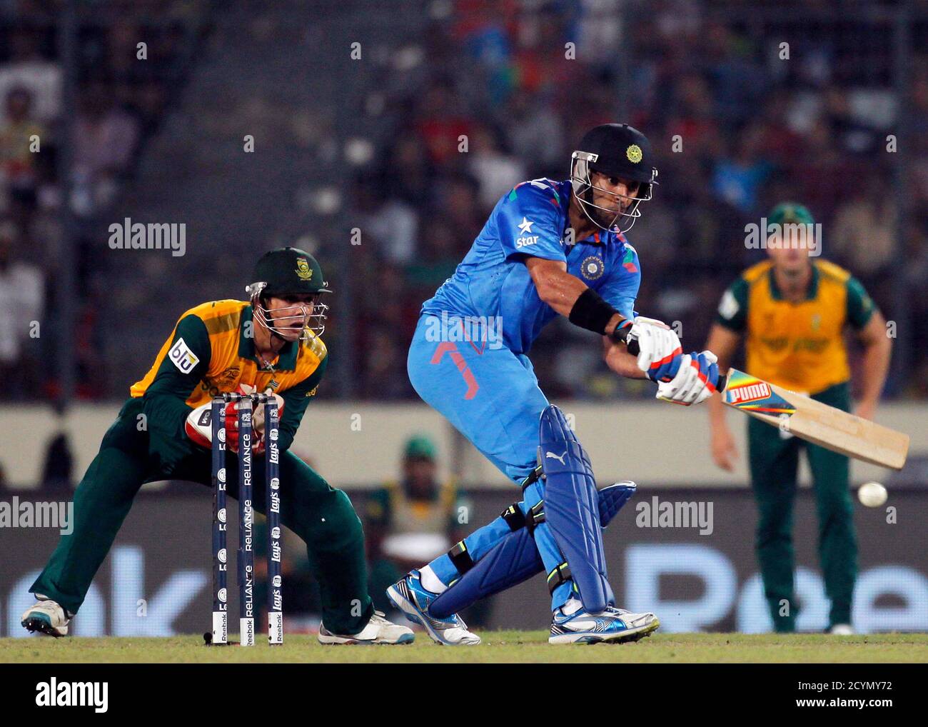 India's Yuvraj Singh plays a ball as South Africa's wicketkeeper Quinton de  Kock (L) watches during their semi final match in the ICC Twenty20 World  Cup at the Sher-E-Bangla National Cricket Stadium