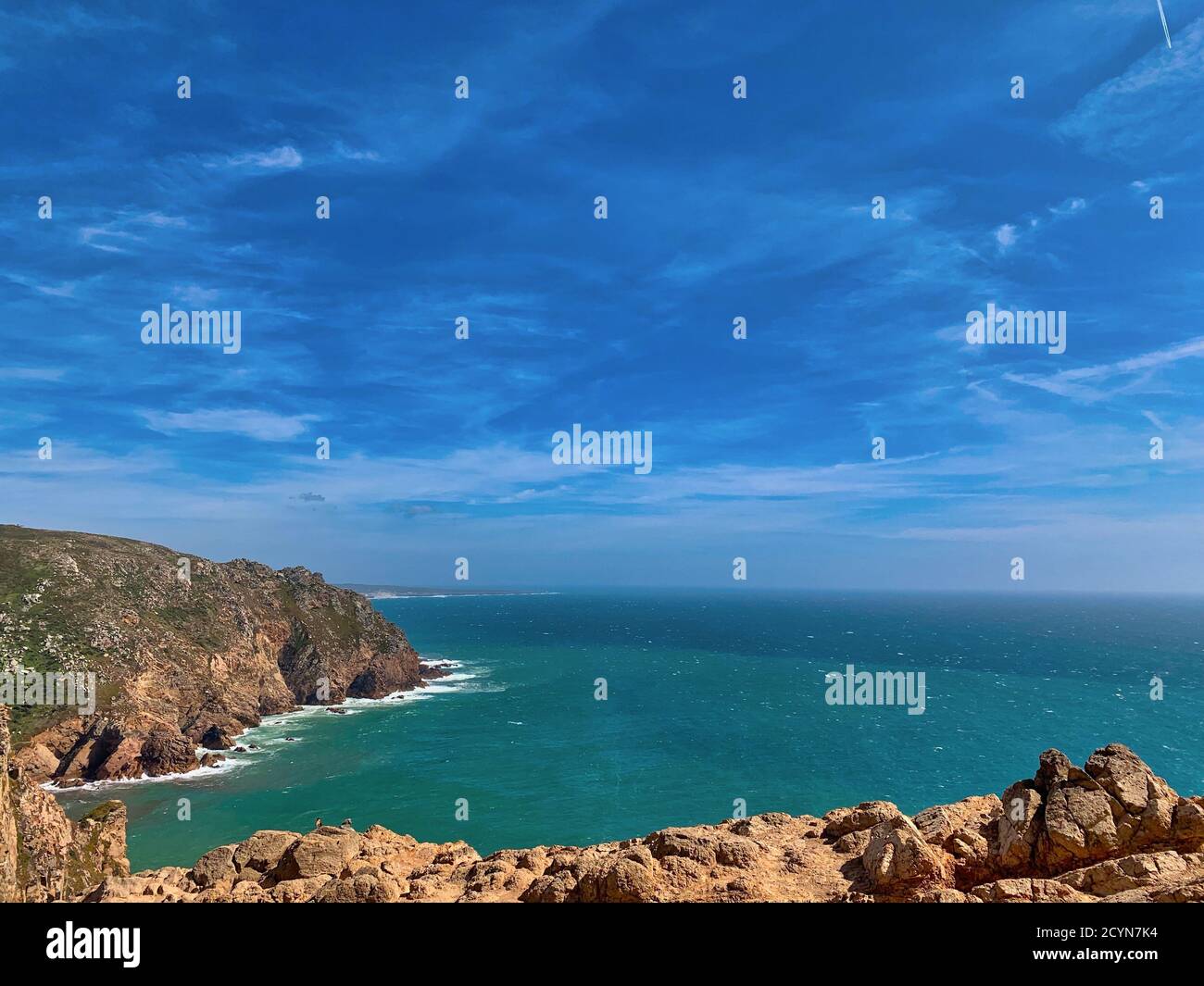 Closeup shot of a rocky beach and the cloudy sky Stock Photo - Alamy