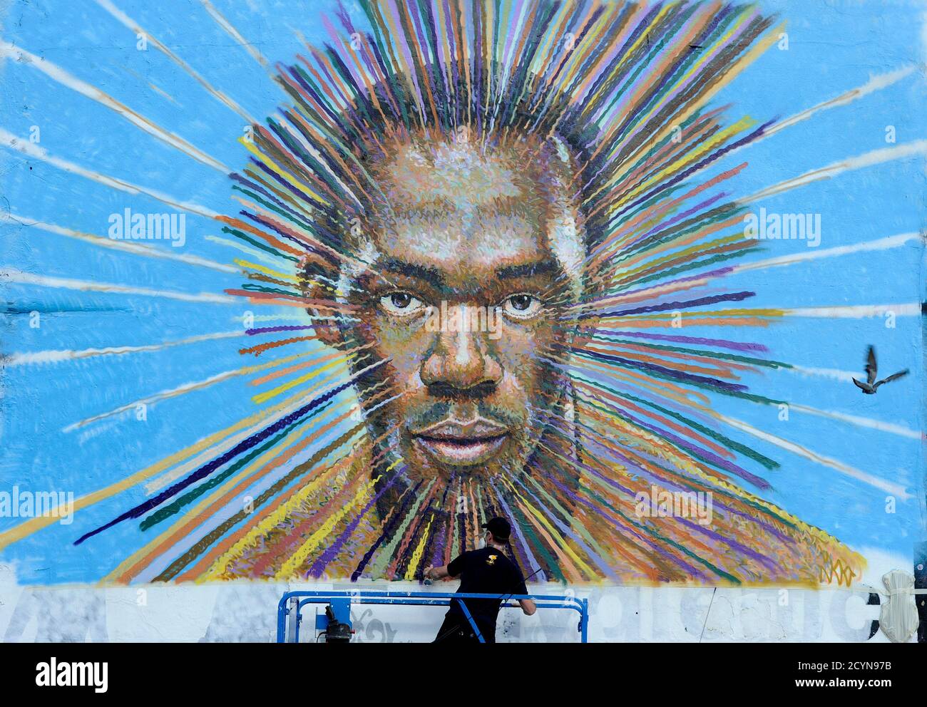 Street artist James Cochran, also known as Jimmy C, works on his spray painted picture of Jamaican sprinter Usain Bolt in Sclater street car park in east London July 19, 2012. Cochran said this was done as an homage to the London 2012 Olympic Games, which begin July 27. REUTERS/Paul Hackett  (BRITAIN - Tags: SPORT OLYMPICS ATHLETICS ENTERTAINMENT) Stock Photo