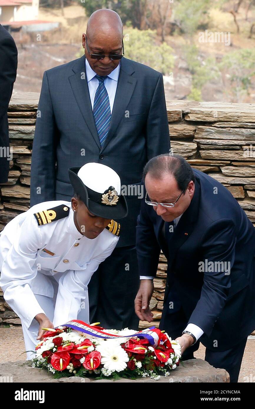 French President Francois Hollande (R) lays a wreath at the Freedom Park monument as South Africa's President Jacob Zuma looks on in Pretoria October 14, 2013. France will lend 100 million euros ($135 million) to South African state power utility Eskom to help it finance solar power projects in Africa's largest economy, according to a communique obtained by Reuters on Monday. The deal will be signed as a part of a summit between Hollande and Zuma, which started on Monday in Pretoria. REUTERS/Siphiwe Sibeko (SOUTH AFRICA - Tags: POLITICS BUSINESS ENERGY) Stock Photo
