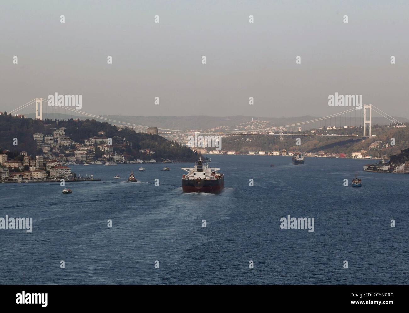 Oil tankers navigate under the Fatih Sultan Mehmet Bridge linking the city's European and Asian sides, over the Bosphorus waterway in Istanbul November 5, 2013. REUTERS/Osman Orsal (TURKEY - Tags: ENERGY MARITIME CITYSCAPE) Stock Photo
