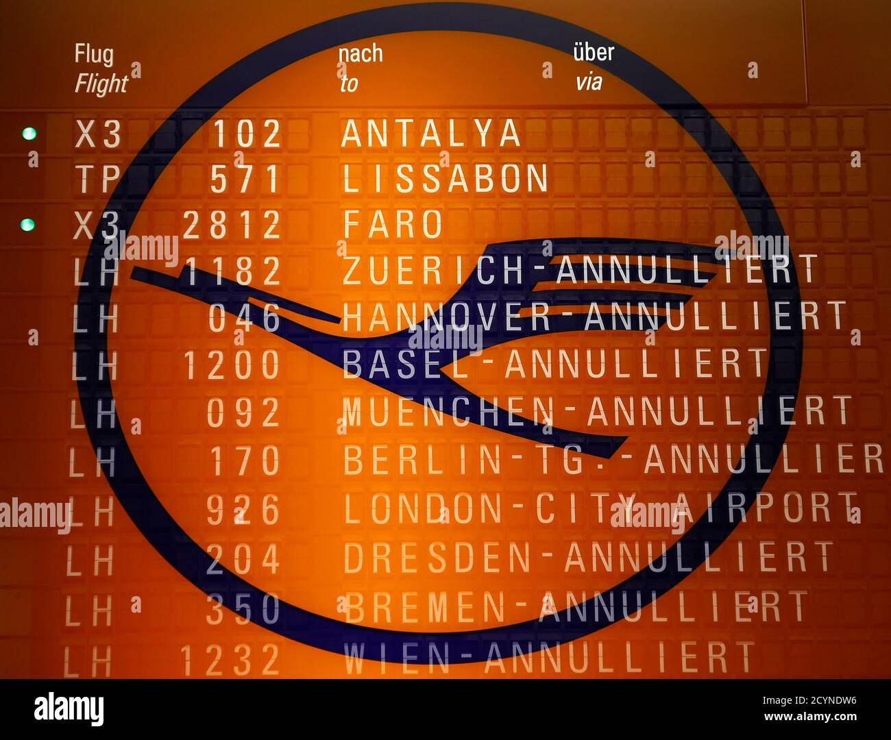 A Picture Taken With The Multiple Exposure Function Of The Camera Shows Cancelled Flights On A Flight Schedule Board And The Logo Of German Air Carrier Lufthansa At The Fraport Airport In