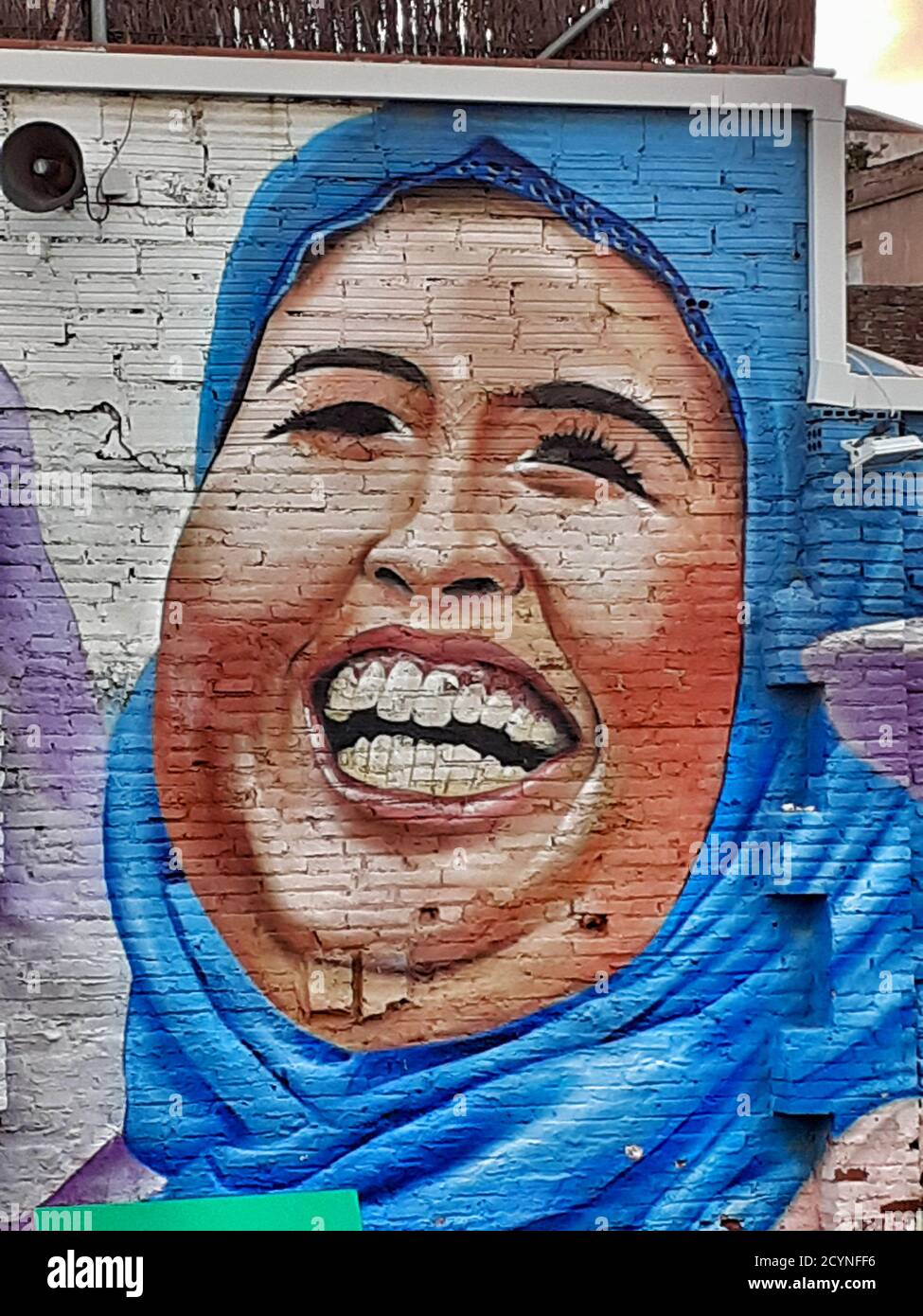 Graffiti of a muslim woman on a wall. Stock Photo