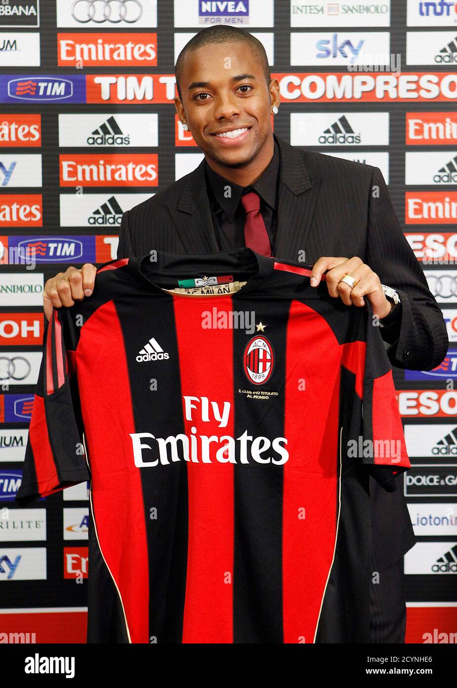 AC Milan's new signing Robinho holds a jersey during a presentation in  downtown Milan September 9, 2010. AC Milan could unleash the full force of  their fearsome frontline foursome, which includes Robinho,