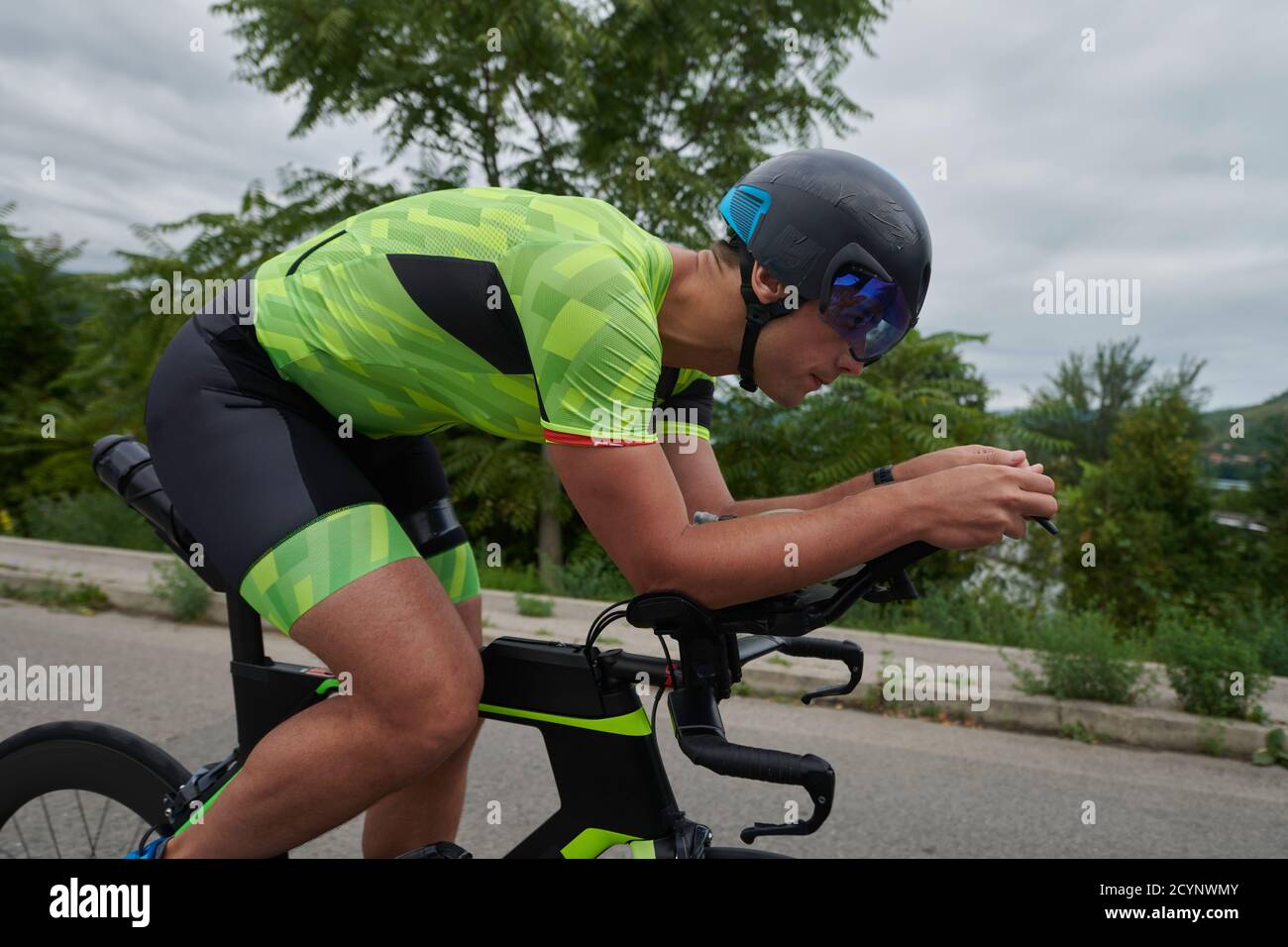triathlon athlete riding a bike on morning training Stock Photo - Alamy