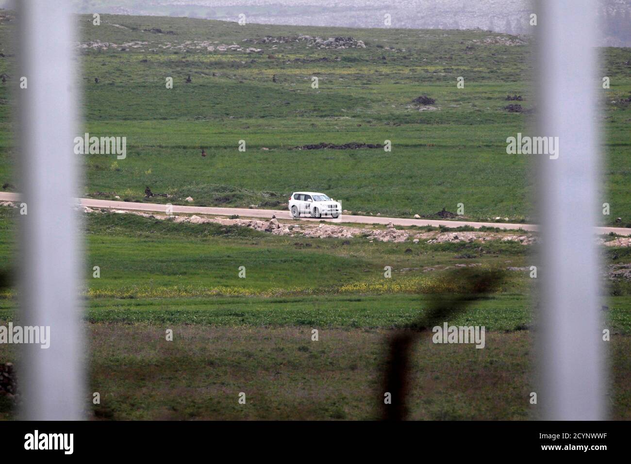 A United Nations vehicle drives near the Syrian village of Al Jamla, close to the ceasefire line between Israel and Syria, as seen from the Israeli occupied Golan Heights March 5, 2013. Syrian rebels have seized a convoy of U.N. peacekeepers near the Golan Heights and say they will hold them captive until President Bashar al-Assad's forces pull back from a rebel-held village which has seen heavy recent fighting. Picture taken March 5, 2013. REUTERS/Baz Ratner (POLITICS CIVIL UNREST) Stock Photo