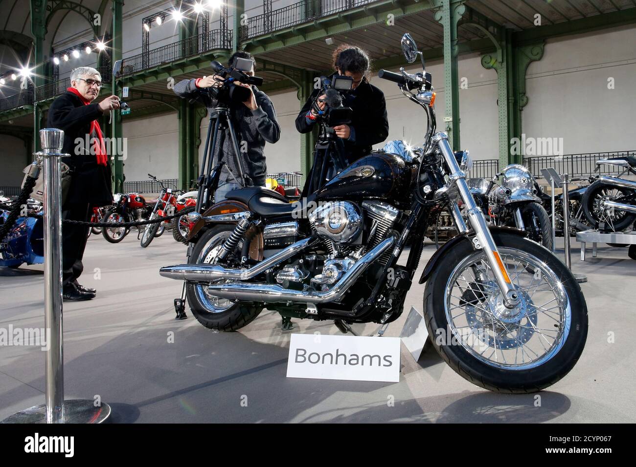 Cameramen Shoot The 1 585 Cc Harley Davidson Dyna Super Glide Donated To Pope Francis Last Year And Signed By Him On Its Tank Which Is Displayed As Part Of Bonham S Les Grandes