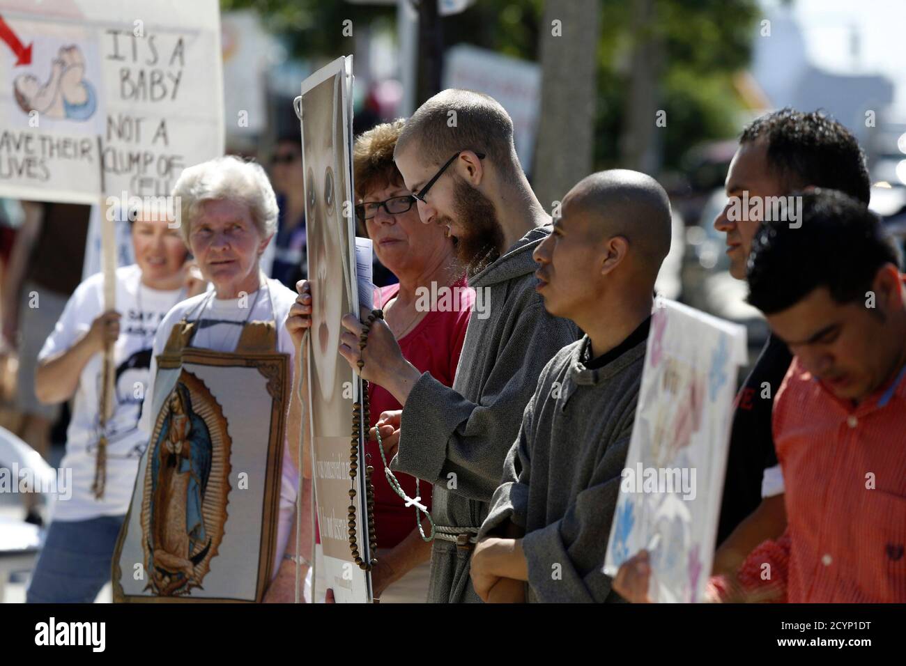 Abortion protesters stand in front of a Planned Parenthood clinic in Boston, Massachusetts, June 28, 2014. Massachusetts is beefing up security around abortion clinics and scrambling for a legal fix after the U.S. Supreme Court voided the state's buffer zone law that kept protesters 35 feet away, saying it violated freedom of speech. Boston, Worcester and Springfield, the state's largest cities, have deployed extra police to clinics, and abortion-provider Planned Parenthood said it was training new 'patient escorts' to help women through protests if needed. REUTERS/Dominick Reuter  (UNITED STA Stock Photo
