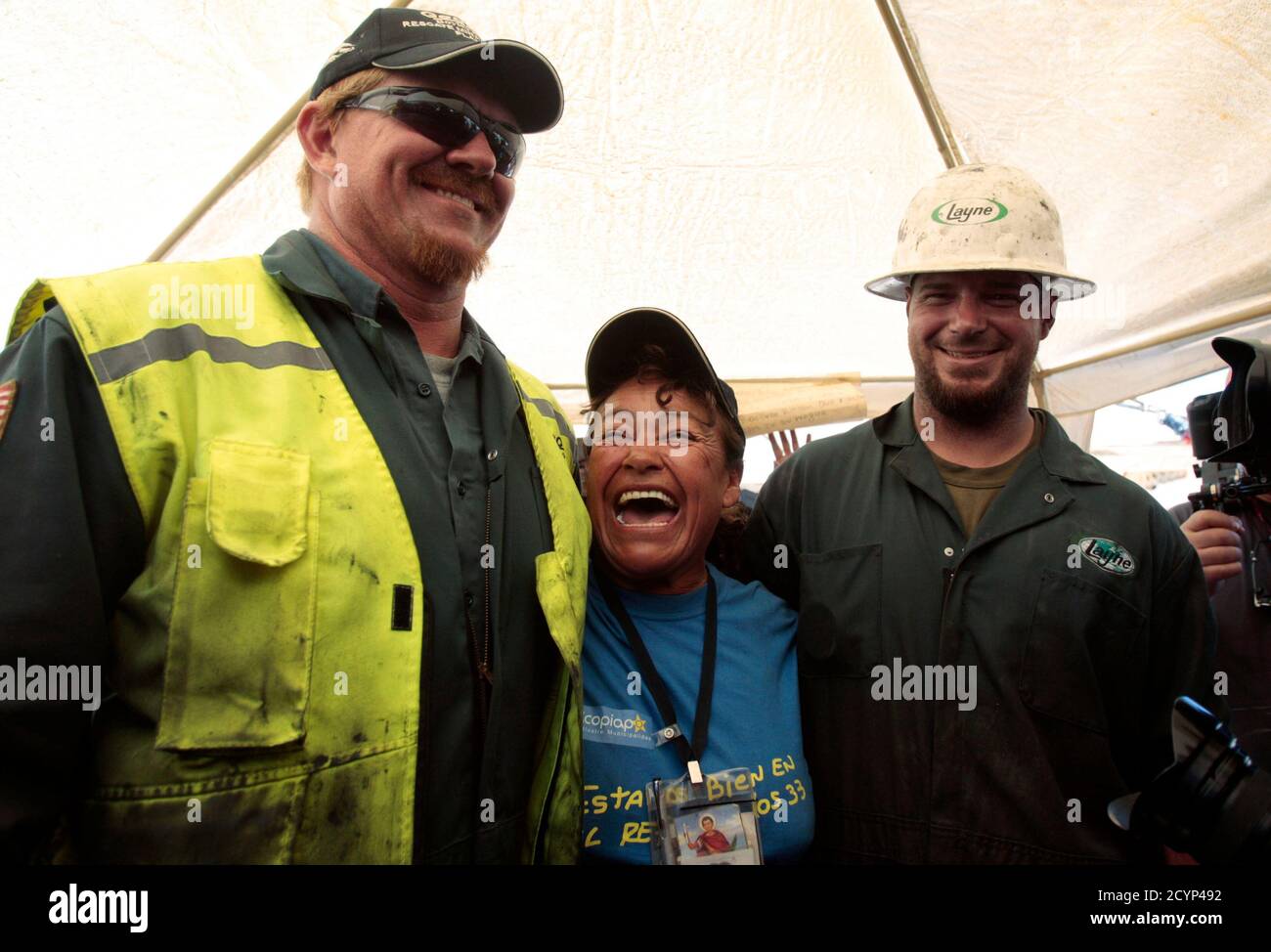 Elizabeth Segovia, sister of Dario Segovia, one of the 33 miners trapped deep underground from an accident on August 5 at San Jose mine, meets with the T 130 drilling machine operators U.S Jeff Heart (L) and Matt Staffel after completing the escape hole for the miners near Copiapo city October 9, 2010. REUTERS/Luis Hidalgo (CHILE - Tags: POLITICS DISASTER EMPLOYMENT BUSINESS SOCIETY IMAGES OF THE DAY) Stock Photo
