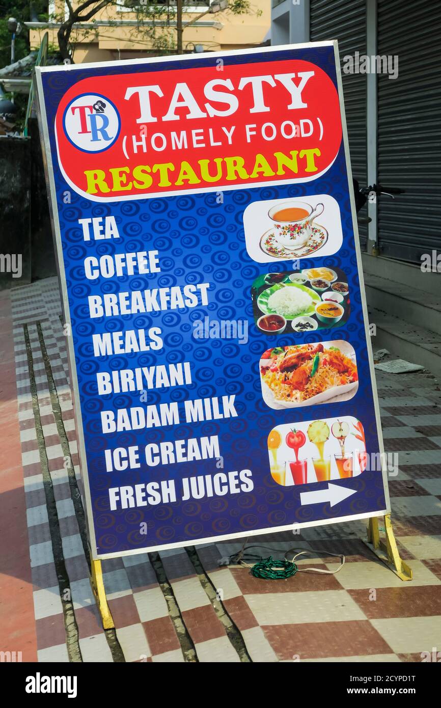 Colourful streetside 'Tasty Restaurant' sign with photos of available