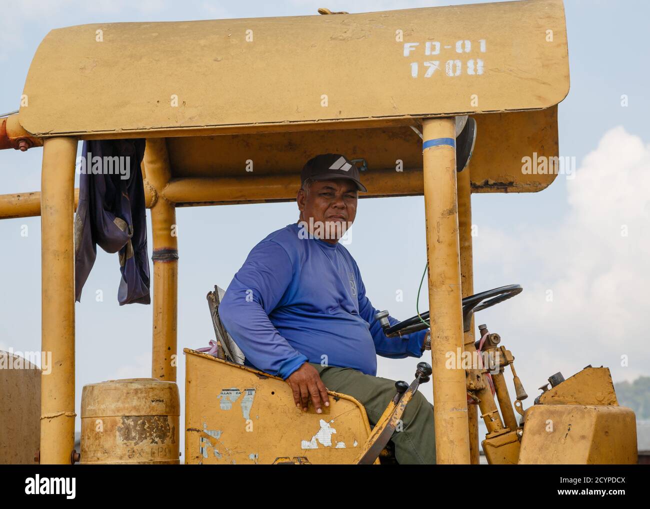 Sandakan, Sabah, Malaysia Operator of a caterpillar for moving peeled