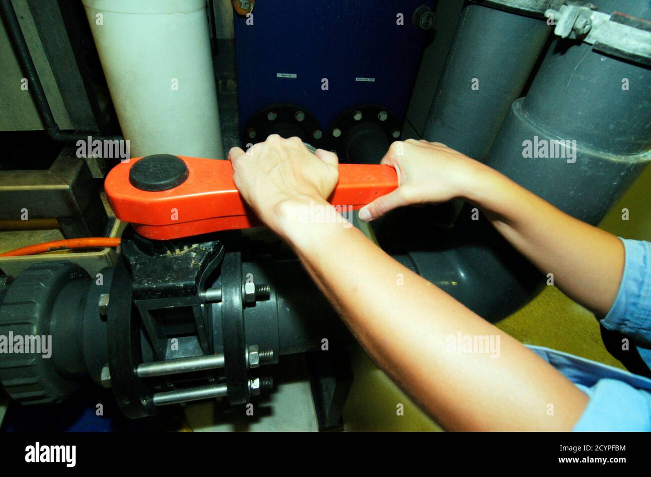 manual opening or closing a valve in an industrial plant Stock Photo ...