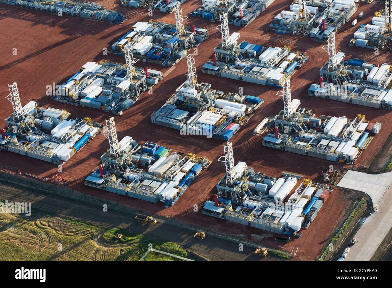 Stacked rigs are seen along with other idled oil drilling equipment at a depot in Dickinson, North Dakota June 26, 2015. Since November, the Saudi Arabian-led OPEC cartel has held to a policy of unconstrained output, an approach many suspect is designed to flood global markets with more crude, push prices lower and punish rivals, including North Dakota, the second-largest U.S. oil producer. REUTERS/Andrew Cullen Stock Photo