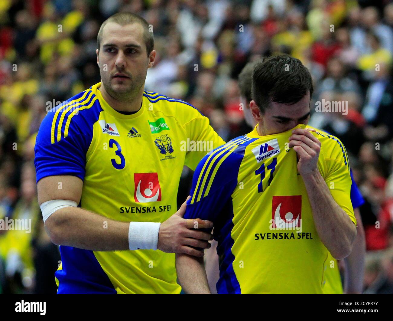 Mattias Gustafsson (L) and Dalibor Doder of Sweden react after losing the  bronze medal match against Spain at the Men's Handball World Championship  in Malmo January 30, 2011. REUTERS/Radu Sigheti (SWEDEN -