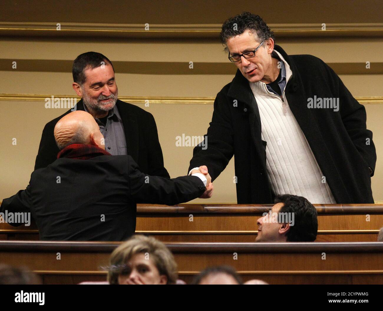 Inaki Antiguedad and Xabier Errekondo (R), congressmen of pro-Basque independence coalition Amaiur, greet former San Sebastian major and Basque Socialist congressman Odon Elorza (L) before the forming of the new parliament at the Spanish parliament in Madrid December 13, 2011. People's Party (Partido Popular) leader and Spain's incoming Prime Minister Mariano Rajoy has said that he does not intend to include Amaiur in a round of meetings with opposition parties unless they condemn the actions of armed Basque separatists ETA. REUTERS/Andrea Comas(SPAIN - Tags: POLITICS) Stock Photo