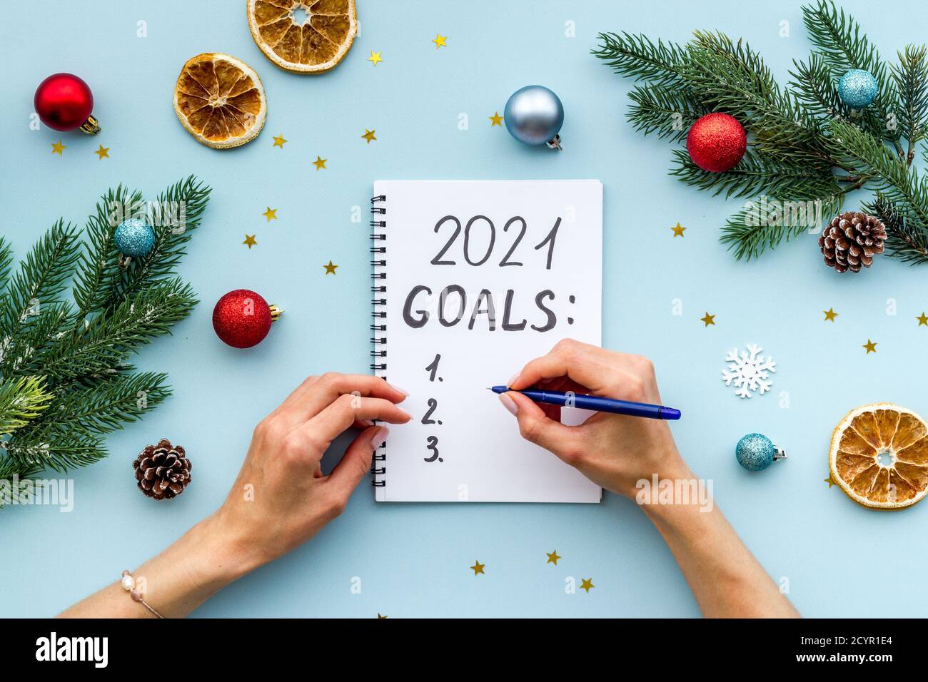 New year goals list. Christmas decorations and notebook on a table ...