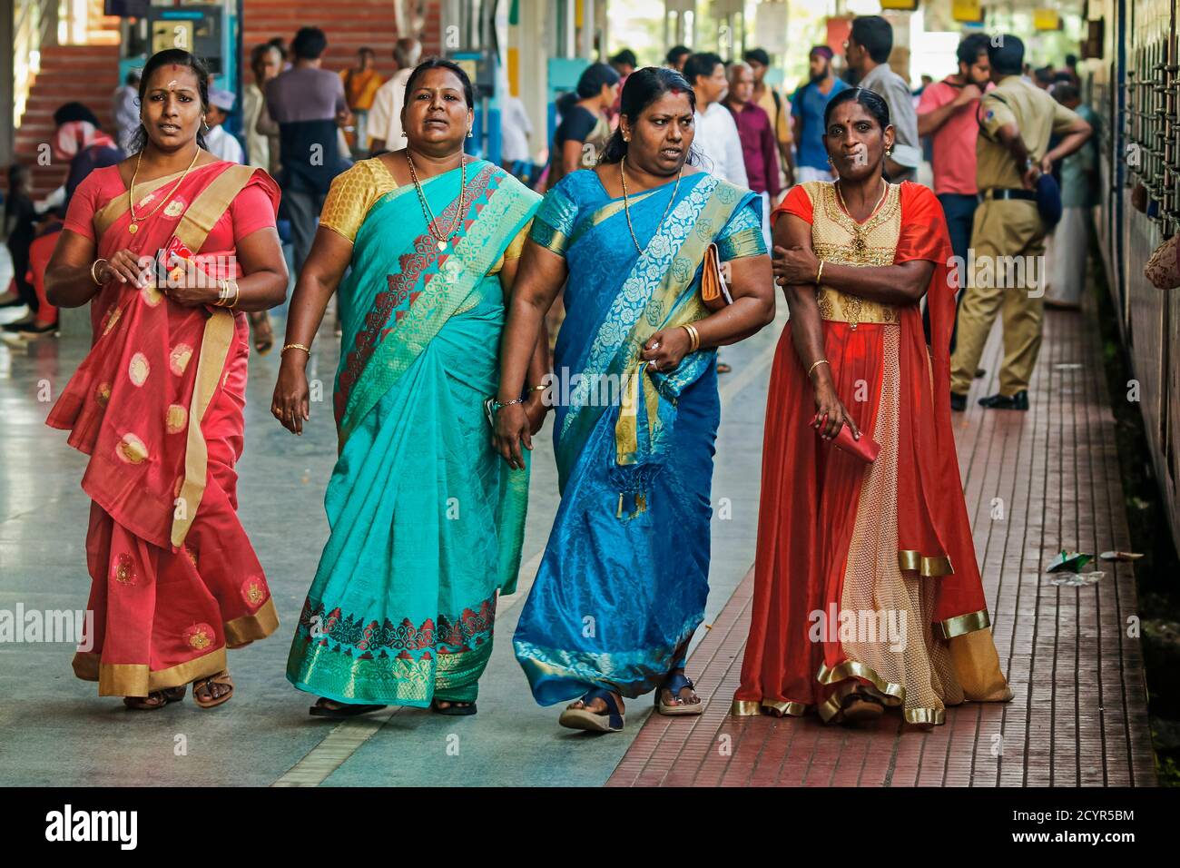 Ladies in colourful traditional clothes at the railway station of