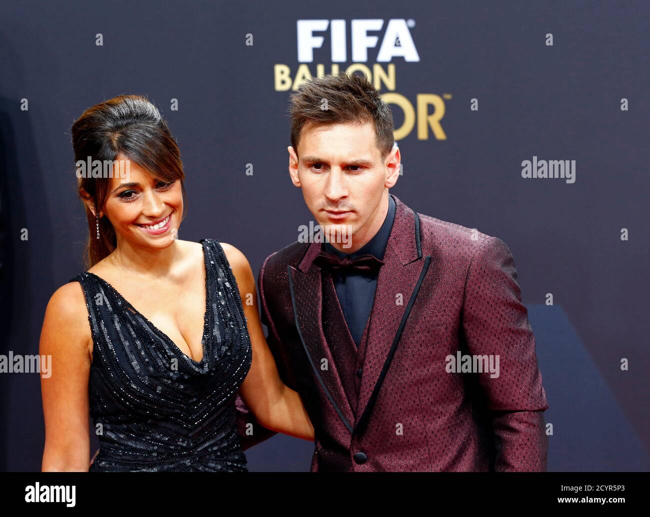 Barcelona's Lionel Messi of Argentina, a nominee for the 2014 FIFA World  Player of the Year, arrives with partner Antonella Roccuzzo for the FIFA Ballon  d'Or 2014 soccer awards ceremony at the