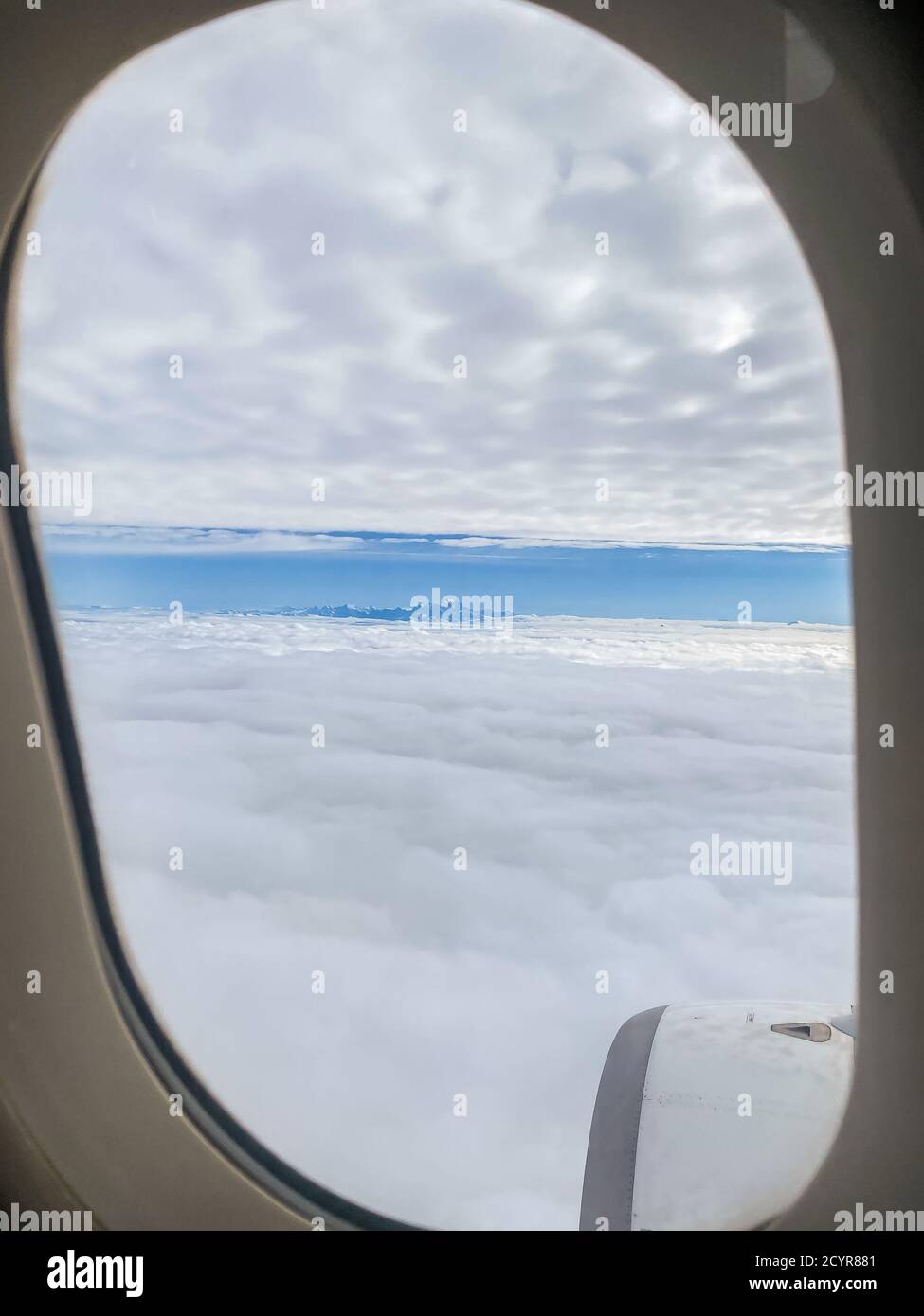 View of the clouds from inside the plane. Stock Photo