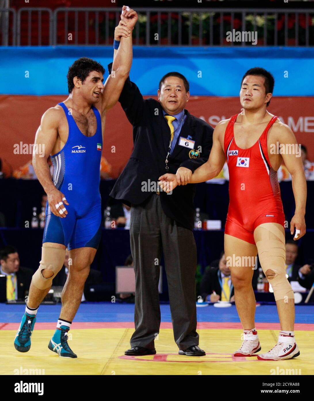 Jamal Mirzaei (L) of Iran has his arm raised after defeating Lee Jae-sung  of South Korea in their men's final 84kg freestyle wrestling bout at the  16th Asian Games in Guangzhou, Guangdong