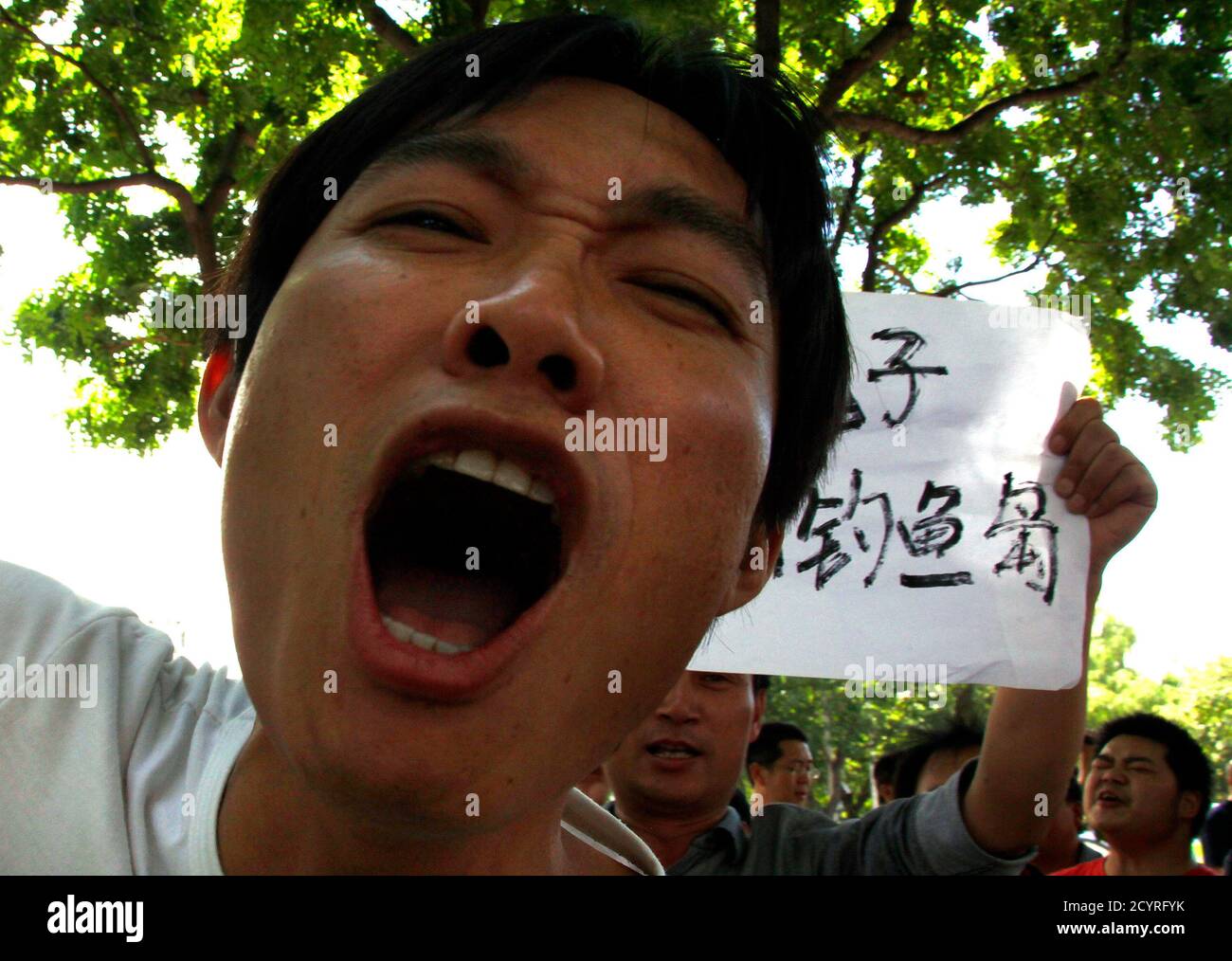 Demonstrators yell slogans and hold banners as they protest outside the Japanese embassy in Beijing September 12, 2012. The United States cautioned China and Japan against escalating a row over a group of islands that both nations claim, warning that tensions between the world's second and third-biggest economies would have global repercussions. On Tuesday, Japan brushed off stern warnings by China and said it had bought the islands from a private Japanese owner. China rained warnings on Japan and official media said Beijing had sent two patrol ships to reassert its claim.   REUTERS/David Gray Stock Photo