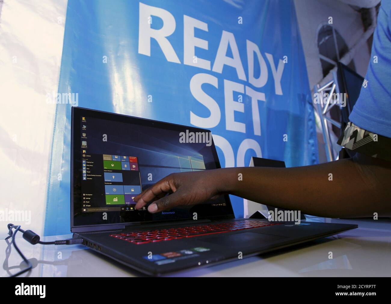 A Microsoft delegate checks applications on a computer during the launch of the Windows 10 operating system in Kenya's capital Nairobi, July 29, 2015. Microsoft Corp's launch of its first new operating system in almost three years, designed to work across laptops, desktop and smartphones, won mostly positive reviews for its user-friendly and feature-packed interface. REUTERS/Thomas Mukoya Stock Photo