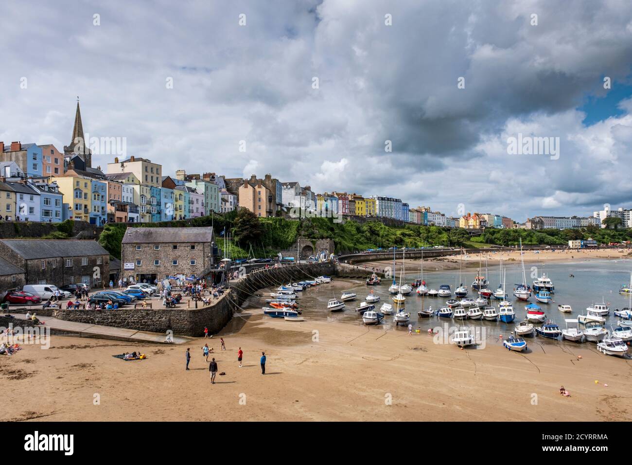 Colourful Regency houses overlook the harbour and North beach at low tide, Tenby, Pembrokeshire Coast National Park, Pembrokeshire, Wales Stock Photo