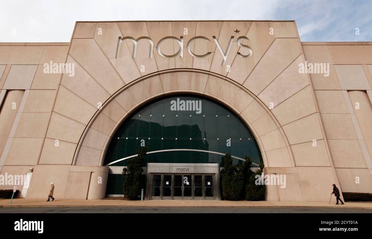 Pedestrians walk by a Macy's store in Arlington, VA, February ...
