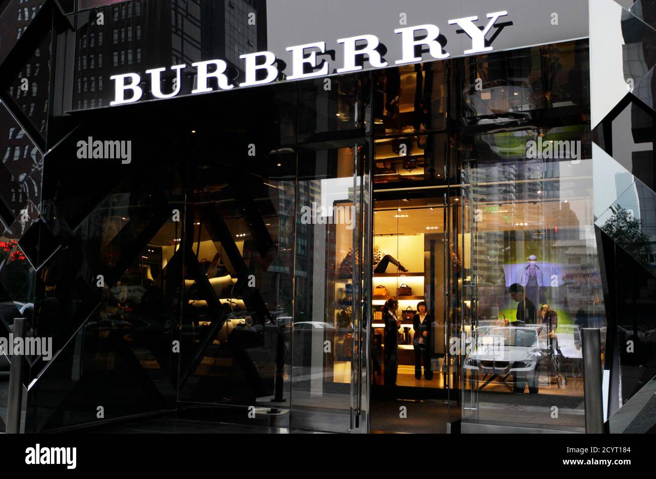 svinge træfning tro Saleswomen wait for customers in a Burberry shop in Beijing, July 11, 2012.  Britain's Burberry provided more evidence of China's economic slowdown on  Wednesday when the luxury goods company reported a decline