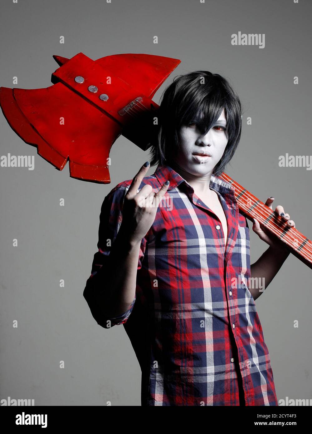 A cosplay enthusiast poses as Marshall Lee of the Adventure Time cartoon  series at the Singapore Toy, Game and Comic Convention September 1, 2013.  The convention featuring 157 exhibitors from 12 countries,