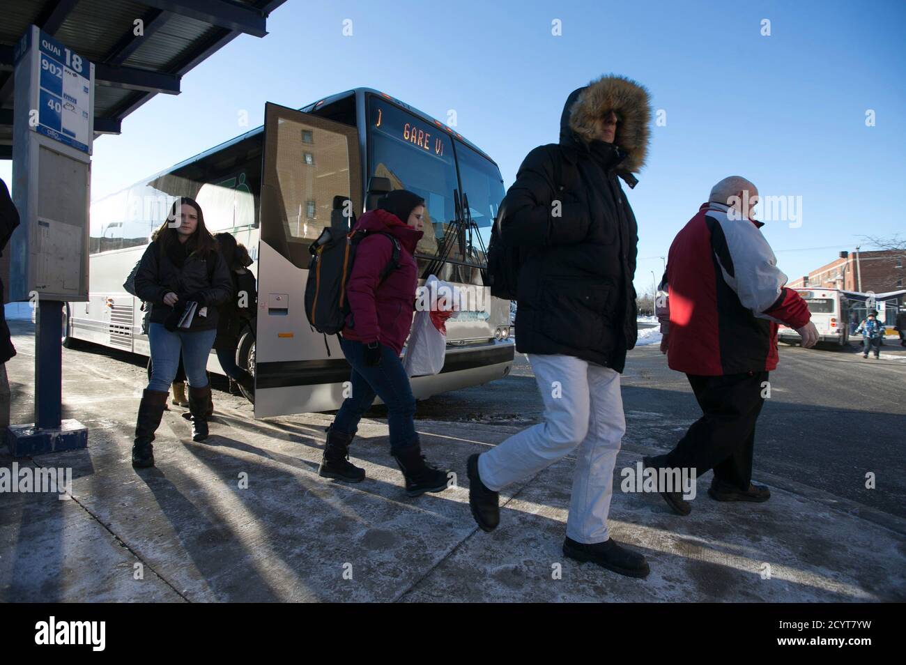 Commuters arrive by special bus from the Vaudreuil-Dorion train station to a metro line at Cote Vertu in Montreal, Quebec, February 16, 2015.  A CP Rail strike left thousands of commuters from three major AMT commuter lines looking for alternate ways to get to work in downtown Montreal.  Canadian Pacific Railway Ltd began operating a reduced freight schedule run by its managers on Sunday, after talks on a new contract broke down and more than 3,000 train engineers and conductors walked off the job. Canada's No. 2 railway and the Teamsters Canada Rail Conference failed to agree on terms includi Stock Photo