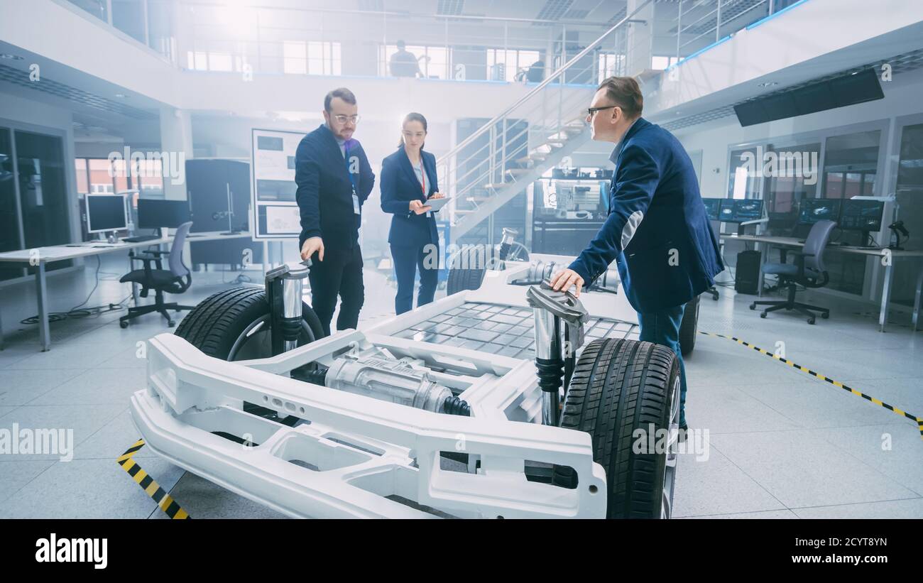 Automotive Design Engineers Talking while Working on Electric Car ...