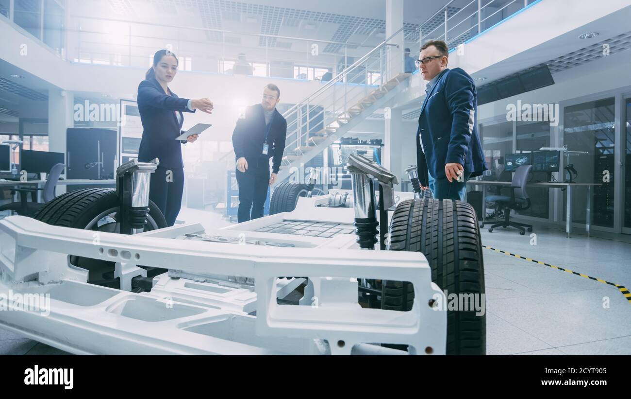 Automotive Design Engineers Talking while Working on Electric Car ...