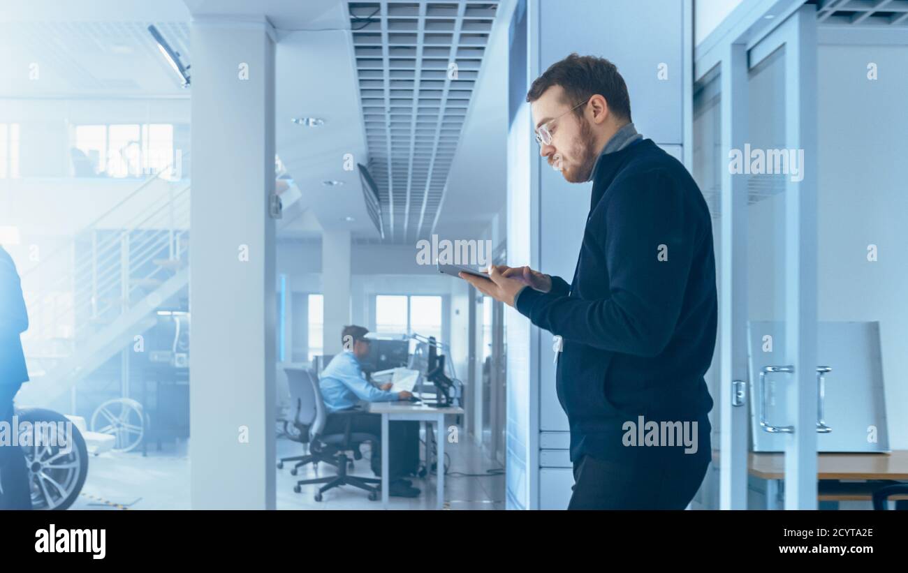 Engineer with Glasses and Beard Enters a High Tech Development Facility ...
