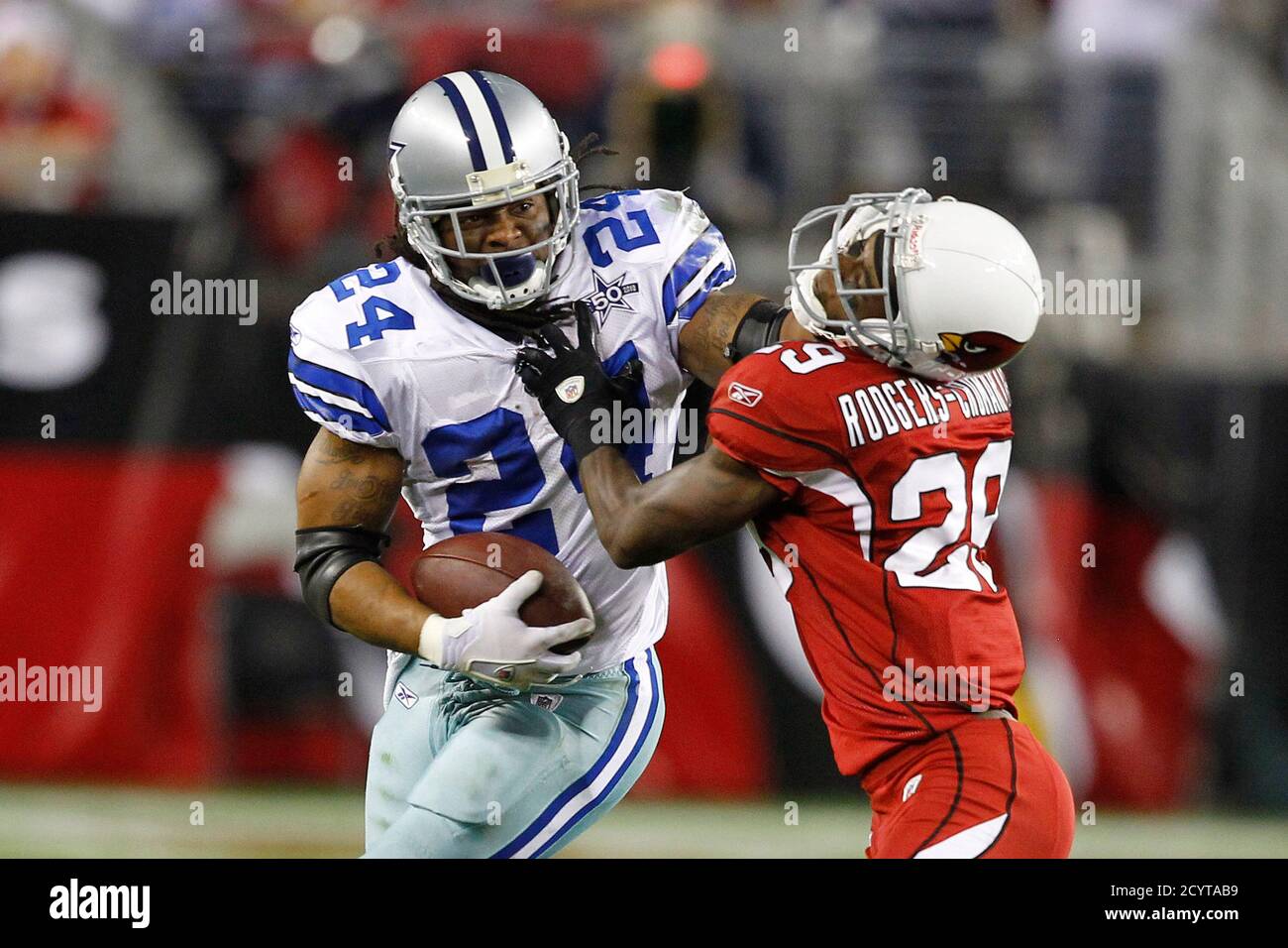 Dallas Cowboys Running Back Marion Barber L Stiff Arms Arizona Cardinals Cornerback Dominique Rodgers Cromartie In