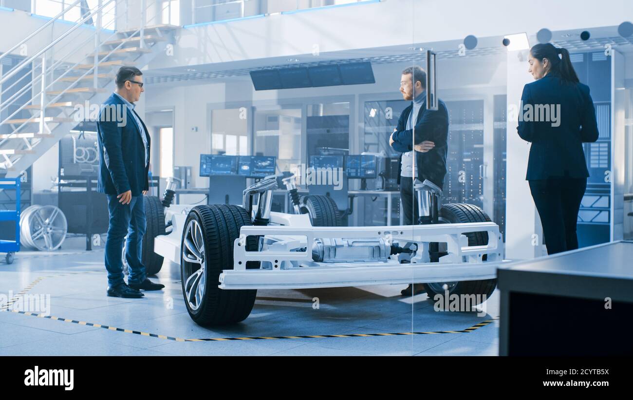 Automotive Design Engineers Talking while Working on Electric Car ...
