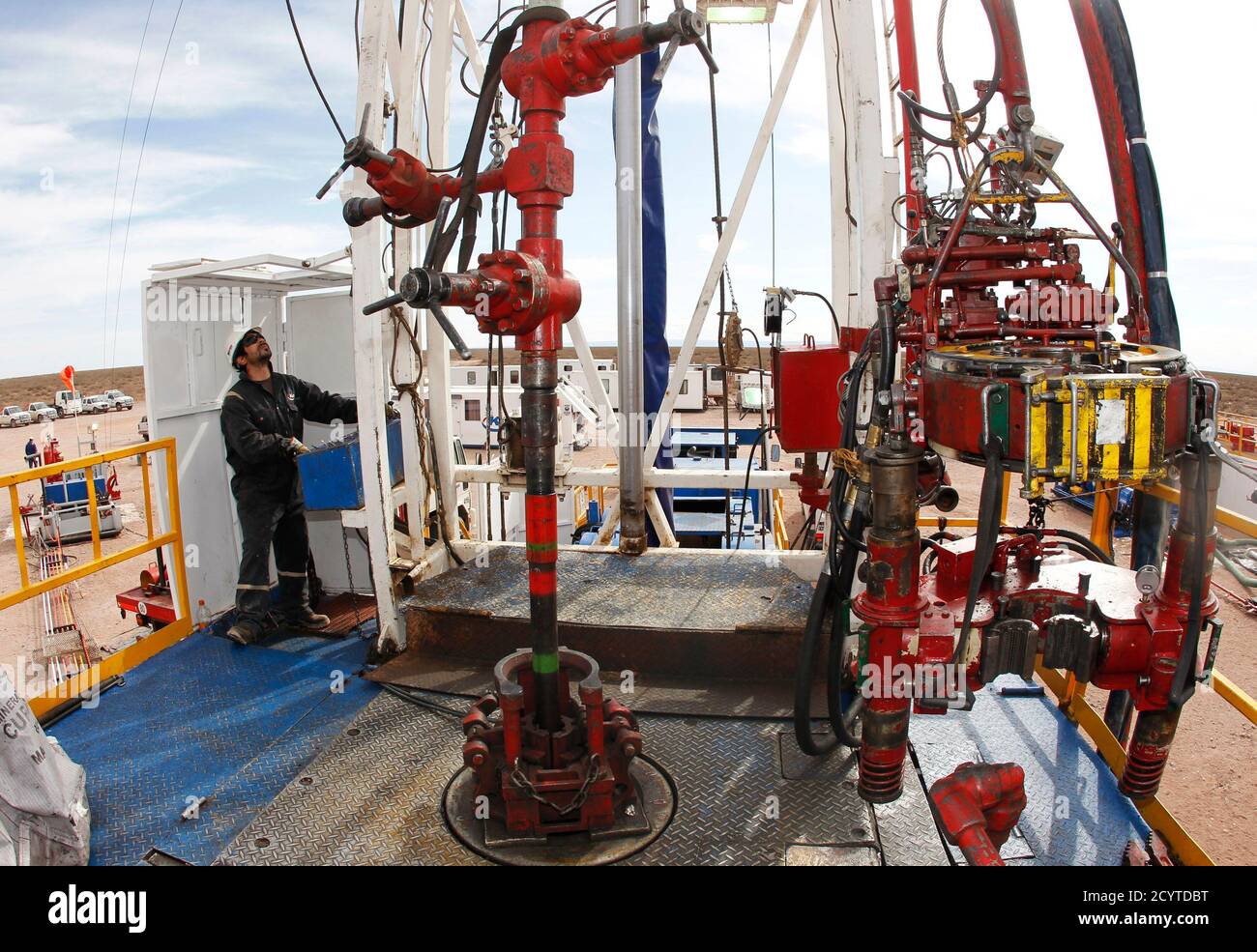 A technician works at a rotary table of a gas and oil drilling rig in the  Patagonian province of Neuquen October 14, 2011. The Patagonia landscape,  which was transformed through the discovery