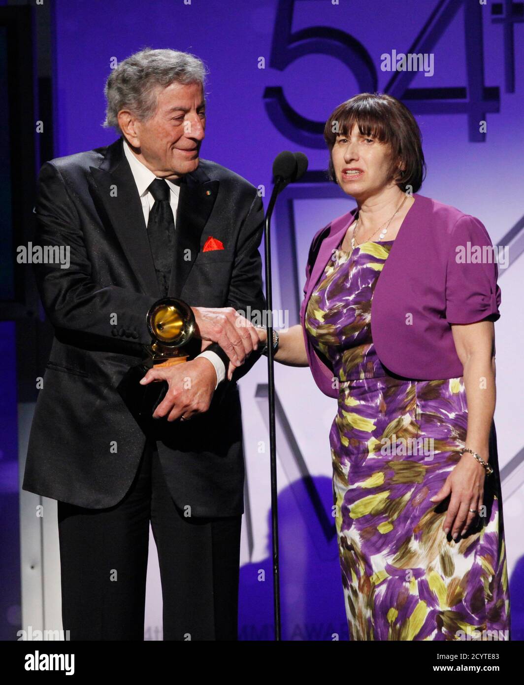 Singer Tony Bennett (L) holds the hand of Janis Winehouse, mother of late  singer Amy Winehouse, after the two singers won "Best Duo/Group  Performance" (Body And Soul) at the 54th annual Grammy