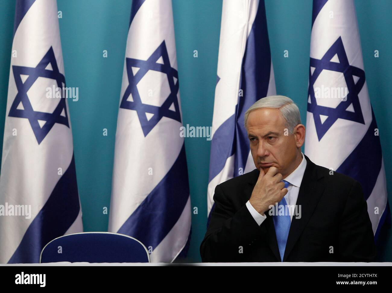 Israel's Prime Minister Benjamin Netanyahu sits after delivering a statement in Jerusalem November 21, 2012. Netanyahu hinted on Wednesday that if an Egyptian-brokered truce with Islamist militants in Gaza did not work Israel would consider 'more severe military action' against the Palestinian territory. REUTERS/Baz Ratner (JERUSALEM - Tags: POLITICS CONFLICT) Stock Photo