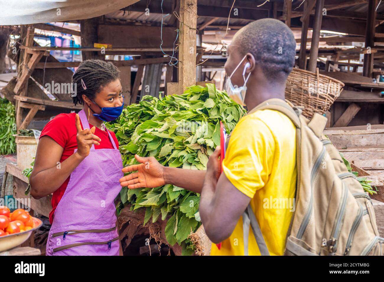 african woman wearing a face mask refuses to shake hands with someone Stock Photo
