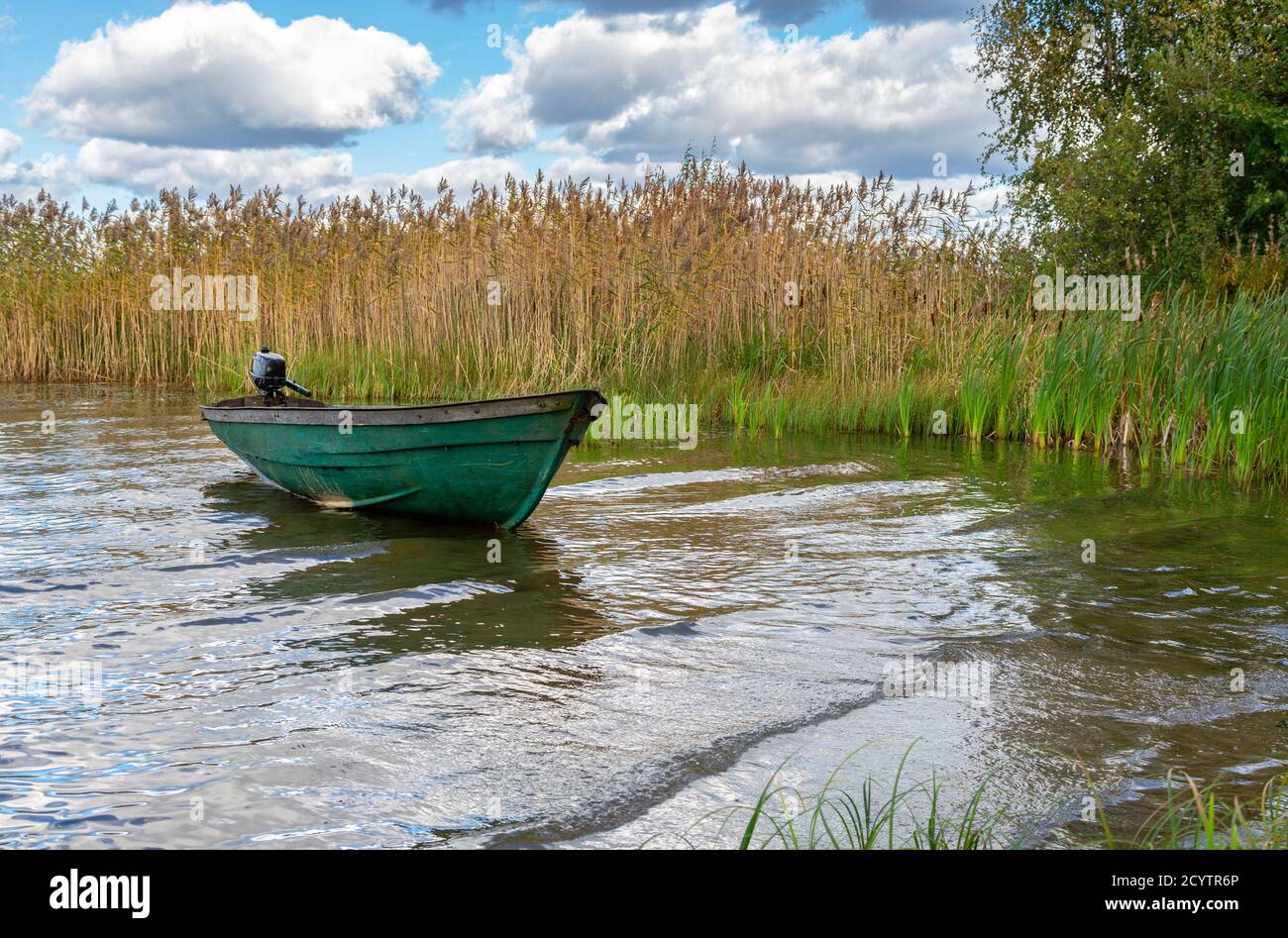 Plastic fishing boat with motor on the lake in summer day. Nature of  northern countries. Environmental landscape Stock Photo - Alamy