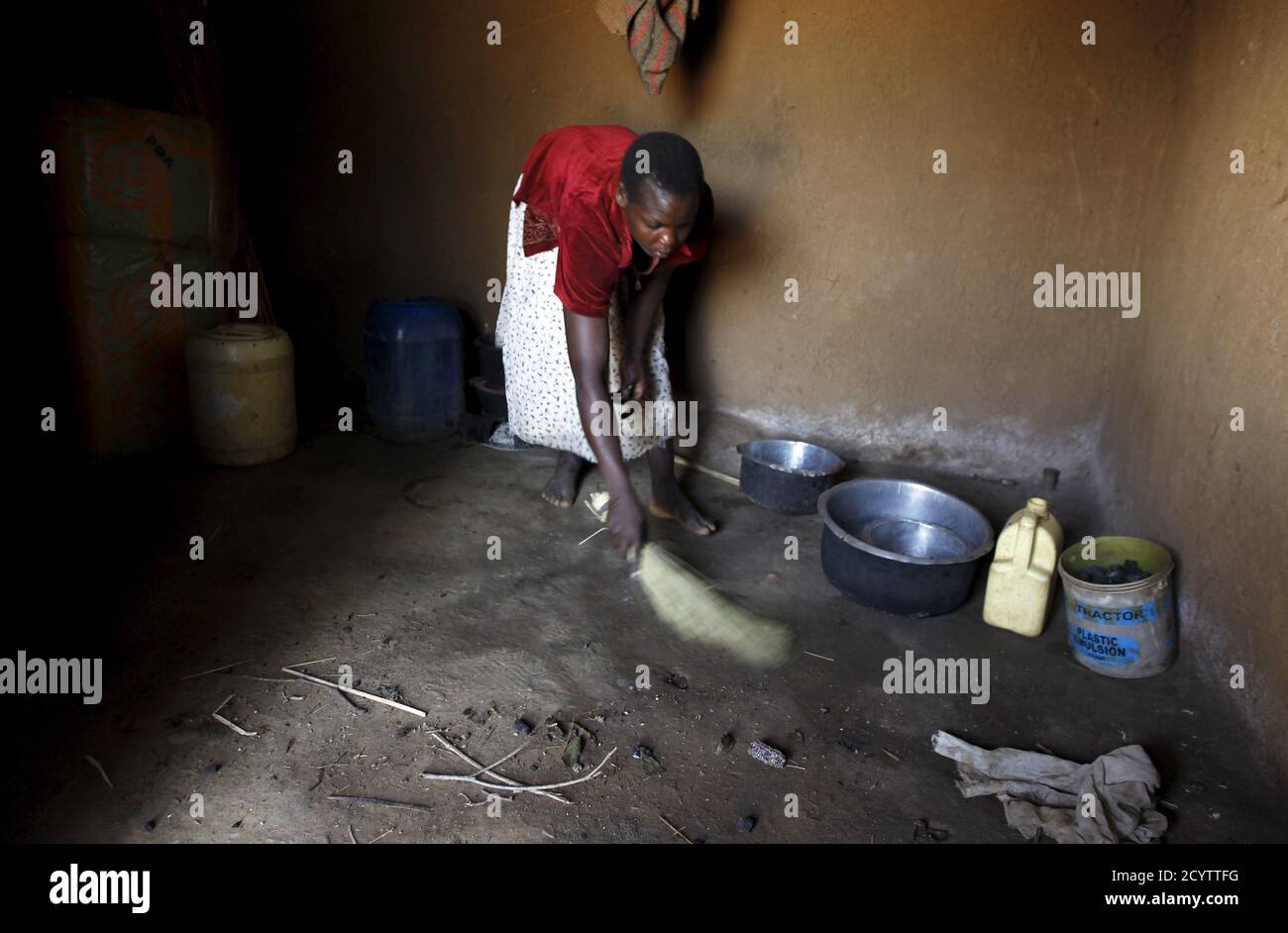 Mary Adhiambo, sweeps her kitchen in the U.S. President Barack Obama's ancestral village of Nyang'oma Kogelo, west of Kenya's capital Nairobi, July 15, 2015. Adhiambi, 25, said they benefited from Barack Obama's Presidency as they have well tarmacked roads and electricity was connected to the village. 'We received grants to build houses and shelter from the harsh weather as an indirect benefit from President Obama's leadership' she said. President Obama visits Kenya and Ethiopia in July, his third major trip to Sub-Saharan Africa after travelling to Ghana in 2009 and to Tanzania, Senegal and S Stock Photo