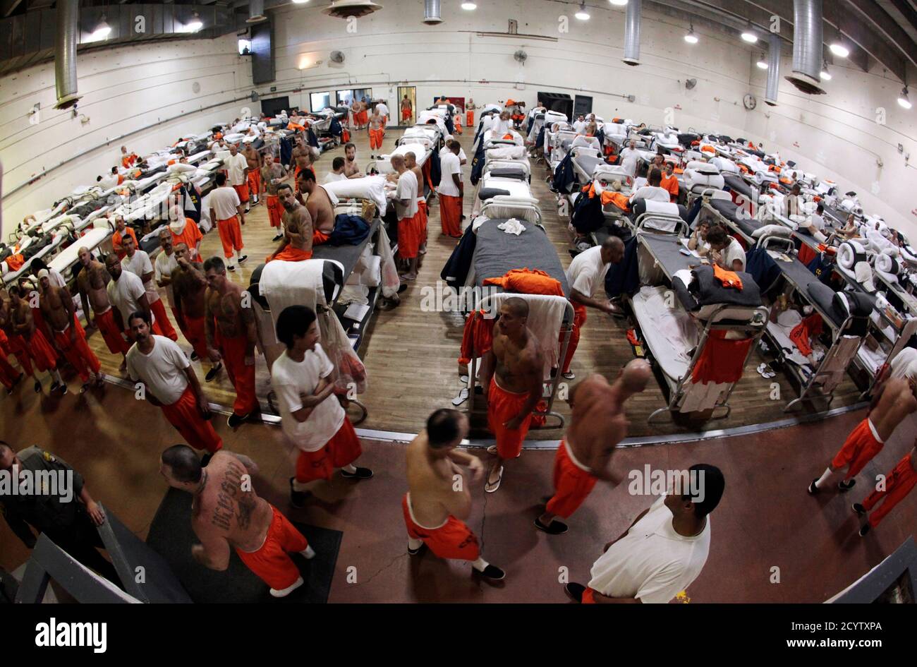 Inmates walk around a gymnasium where they are housed due to overcrowding at the California Institution for Men state prison in Chino, California, June 3, 2011. The Supreme Court has ordered California to release more than 30,000 inmates over the next two years or take other steps to ease overcrowding in its prisons to prevent 'needless suffering and death.' California's 33 adult prisons were designed to hold about 80,000 inmates and now have about 145,000. The U.S. has more than 2 million people in state and local prisons. It has long had the highest incarceration rate in the world. REUTERS/L Stock Photo